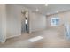 Bright loft features neutral carpet, natural light from a window, and a doorway into another room at 8609 Cheraw St, Littleton, CO 80125