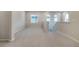 Spacious loft area with neutral carpet, multiple windows, and staircase leading to another level at 8609 Cheraw St, Littleton, CO 80125