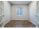 Versatile office space with neutral walls, a window with blinds, and stylish wood flooring at 8609 Cheraw St, Littleton, CO 80125