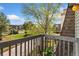 Balcony overlooking mature trees, blue skies, sidewalks, and neighboring townhomes at 1370 S Idalia St # A, Aurora, CO 80017