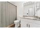 Bathroom featuring a white vanity, shower with curtain and an updated mirror at 1370 S Idalia St # A, Aurora, CO 80017