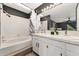 Bathroom with double vanity, tiled floor, soaking tub, bright vanity lights and a shower at 1370 S Idalia St # A, Aurora, CO 80017