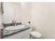 Well-lit half bathroom with updated vanity and fixtures, with tile floors at 1370 S Idalia St # A, Aurora, CO 80017