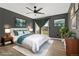 This spacious bedroom features a ceiling fan, hardwood floors, and sliding glass doors to a deck at 1370 S Idalia St # A, Aurora, CO 80017