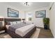 This bedroom features neutral walls, hardwood floors, a picture window, and tasteful art at 1370 S Idalia St # A, Aurora, CO 80017
