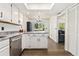 Eat-in kitchen with island, stone countertops, stainless appliances, and hardwood floors at 1370 S Idalia St # A, Aurora, CO 80017