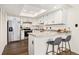 Bright kitchen features stainless steel appliances, stone countertops, breakfast bar, and a skylight at 1370 S Idalia St # A, Aurora, CO 80017