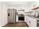 Updated kitchen with stainless steel appliances, stylish countertops, and ample white cabinetry at 1370 S Idalia St # A, Aurora, CO 80017