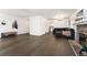 Large living area with hardwood floors, a stone fireplace, and open access to the kitchen at 1370 S Idalia St # A, Aurora, CO 80017
