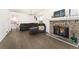 Inviting living room featuring a stone fireplace, comfortable seating, and hardwood flooring at 1370 S Idalia St # A, Aurora, CO 80017
