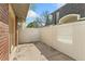 Private patio with white fencing and a peak at the townhome's brick facade at 1370 S Idalia St # A, Aurora, CO 80017