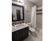 Bathroom featuring shower-tub combination with tiled walls, sleek vanity, and updated fixtures at 1863 S Pitkin Cir # B, Aurora, CO 80017