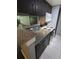 Stylish kitchen featuring granite countertops, dark cabinets, a microwave, and a white stove at 1863 S Pitkin Cir # B, Aurora, CO 80017