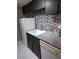 Kitchen area featuring granite countertops, white appliances, dark cabinets, and a tiled backsplash at 1863 S Pitkin Cir # B, Aurora, CO 80017