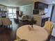 Open-concept living area with fireplace, dining table, hardwood floors, and modern kitchen at 1863 S Pitkin Cir # B, Aurora, CO 80017