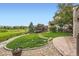 Secluded backyard offers a playset and serene views of the neighborhood green space and manicured garden beds at 989 Graland Pl, Highlands Ranch, CO 80126