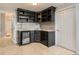 Entertainment area with built in bar boasts tile flooring, custom cabinetry, and a wine fridge at 989 Graland Pl, Highlands Ranch, CO 80126