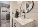 Stylish powder room featuring a modern vanity with marble countertop, shiplap walls, and trendy fixtures at 989 Graland Pl, Highlands Ranch, CO 80126