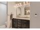 Elegant bathroom boasts a granite countertop and and vessel sinks beneath a decorative vanity light at 989 Graland Pl, Highlands Ranch, CO 80126