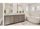 Bright bathroom boasts a soaking tub, double vanity, and neutral colors at 989 Graland Pl, Highlands Ranch, CO 80126
