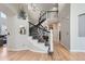 Grand entryway showcasing a curved staircase, hardwood floors, and elegant decor, providing a welcoming ambiance at 989 Graland Pl, Highlands Ranch, CO 80126