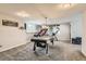 Bright game room features games, carpet and natural light at 989 Graland Pl, Highlands Ranch, CO 80126