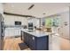 Beautiful kitchen featuring white cabinetry, a blue island, stainless appliances, and a dining area near the patio at 989 Graland Pl, Highlands Ranch, CO 80126