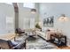 Well-lit living room with high ceilings, plantation shutters, modern lighting, and stylish furniture arrangement at 989 Graland Pl, Highlands Ranch, CO 80126