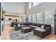 Sunlit living room boasts soaring ceilings, a spacious layout, and seamless connection to an open-concept kitchen at 989 Graland Pl, Highlands Ranch, CO 80126