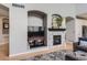 Beautiful living room with a modern fireplace, built-in shelving, and a comfortable seating area with hardwood floors at 989 Graland Pl, Highlands Ranch, CO 80126