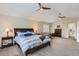 Spacious main bedroom features vaulted ceilings, ceiling fans, neutral colors and ensuite bathroom access at 989 Graland Pl, Highlands Ranch, CO 80126