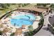 Aerial view of a community pool with tanning decks, lounge chairs and landscaped green spaces at 16488 W 92Nd Pl, Arvada, CO 80007
