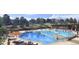Large community pool with lounge chairs, waterfalls, and seating for relaxation and recreation at 16488 W 92Nd Pl, Arvada, CO 80007