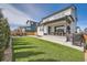 Well-maintained backyard with a spacious lawn, patio seating, and a privacy fence at 2840 E 102Nd Pl, Thornton, CO 80229