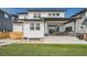 Beautiful home's backyard featuring a covered patio, outdoor dining area, and lush green lawn at 2840 E 102Nd Pl, Thornton, CO 80229