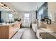 Bright bathroom with a double vanity, soaking tub, and a glass-enclosed shower at 2840 E 102Nd Pl, Thornton, CO 80229