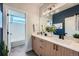 Well-lit bathroom with a modern vanity, dual sinks, and a shower/tub combo at 2840 E 102Nd Pl, Thornton, CO 80229