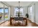 Modern dining room with a wooden table, stylish light fixture, and sliding glass doors to the patio at 2840 E 102Nd Pl, Thornton, CO 80229