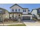 Charming two-story home with white siding, a welcoming front porch, and a two-car garage at 2840 E 102Nd Pl, Thornton, CO 80229