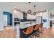 Modern kitchen features an island with bar seating, white cabinets, and stainless steel appliances at 2840 E 102Nd Pl, Thornton, CO 80229