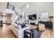Spacious living room with soaring ceilings, a fireplace, large windows, and modern decor at 2840 E 102Nd Pl, Thornton, CO 80229