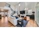 Open concept living room with a staircase, fireplace, modern furnishings, and lots of natural light at 2840 E 102Nd Pl, Thornton, CO 80229