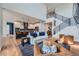 Open-concept living space connecting the living room and kitchen with modern finishes and lots of light at 2840 E 102Nd Pl, Thornton, CO 80229