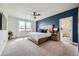 Spacious main bedroom with an ensuite bathroom, large window, and comfortable bed at 2840 E 102Nd Pl, Thornton, CO 80229