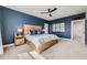 Cozy main bedroom featuring a wood bed frame, accent wall, and ensuite bathroom at 2840 E 102Nd Pl, Thornton, CO 80229