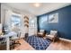Bright home office with natural light, a modern desk, and a comfortable seating area at 2840 E 102Nd Pl, Thornton, CO 80229
