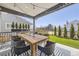 Inviting covered patio with a dining table, chairs, and a view of the backyard at 2840 E 102Nd Pl, Thornton, CO 80229