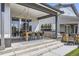 Covered patio with outdoor dining set, grill, and stylish lighting at 2840 E 102Nd Pl, Thornton, CO 80229