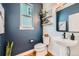 Chic powder room featuring a pedestal sink, decorative mirror, and stylish wall decor at 2840 E 102Nd Pl, Thornton, CO 80229