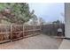 Wood privacy fence surrounds the gravel backyard area of this townhome at 4504 S Cimmarron Cir # D, Aurora, CO 80015